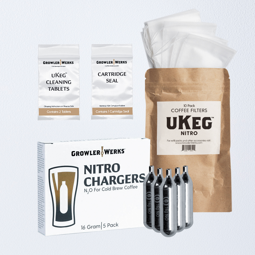 A plastic bag labeled "uKeg Cleaning Tablets", a plastic bag labeled "Cartridge Seal", a brown bag labeled "uKeg Nitro Coffee Filters", a white box with black lettering labeled "GrowlerWerks Nitro Chargers 5-pack", and five stainless steel 16g Nitro Chargers, on a  light grey background.